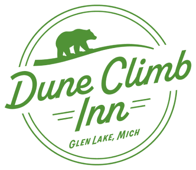 The green circular logo for Dune Climb Inn features a bear silhouette and a thin border.